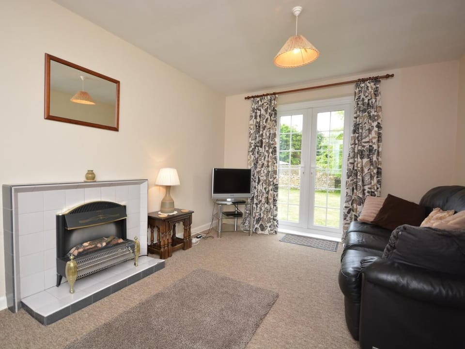 Spacious relaxing lounge with double doors to the garden