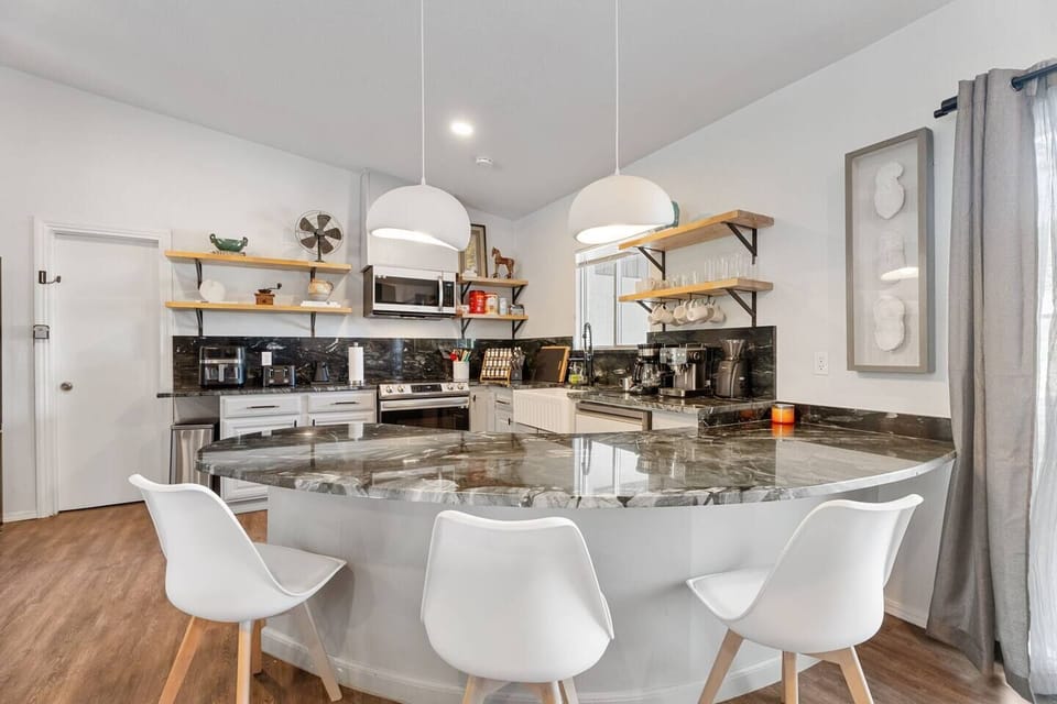 Gather around in this open-concept dining and kitchen space, designed for shared meals and warm conversations.