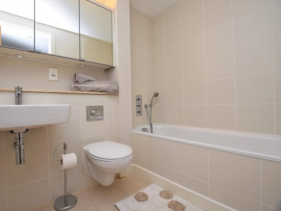 Bathroom with bath with hand-held shower