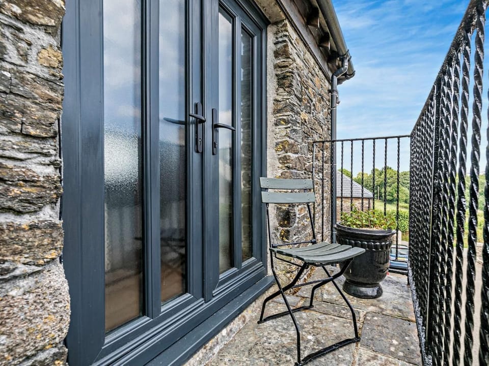 Small balcony accessed from upper floor doors or steps