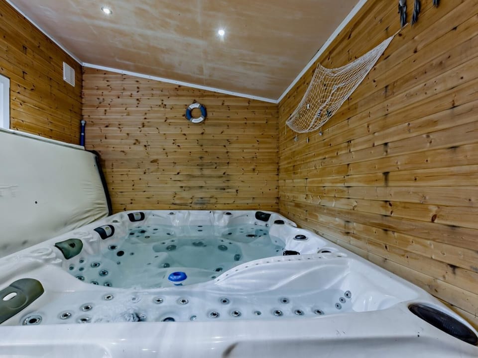 Large sunken hot tub seating 8 people