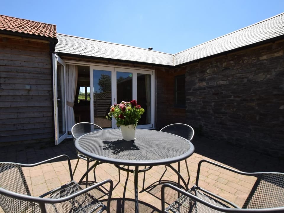 Outside patio area with bi-folding doors into the living room 