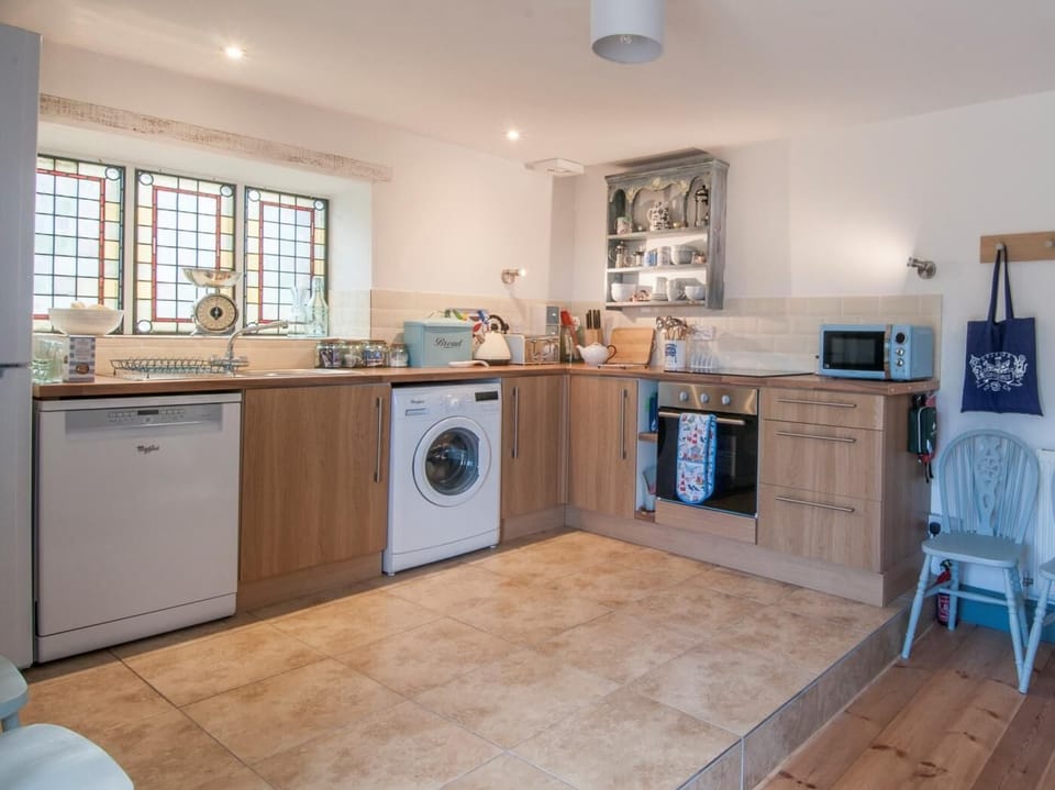 The spacious kitchen has stained glass windows