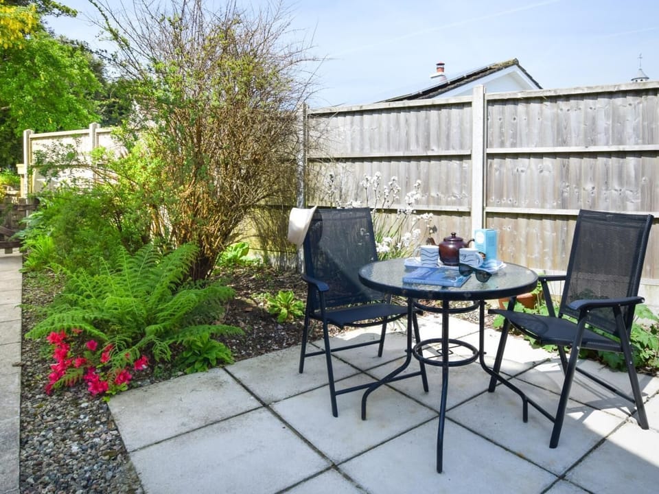 A pretty and enclosed side garden is just one of two outside seating areas here