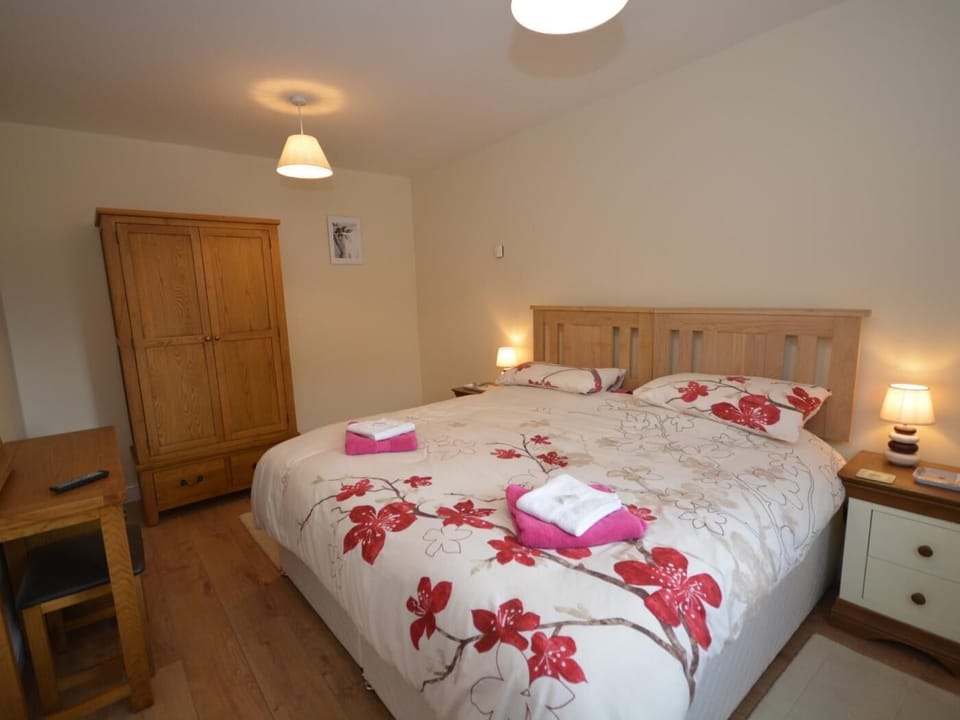 Spacious master bedroom made up with super-king-size bed with space for the cot or additional single bed 
