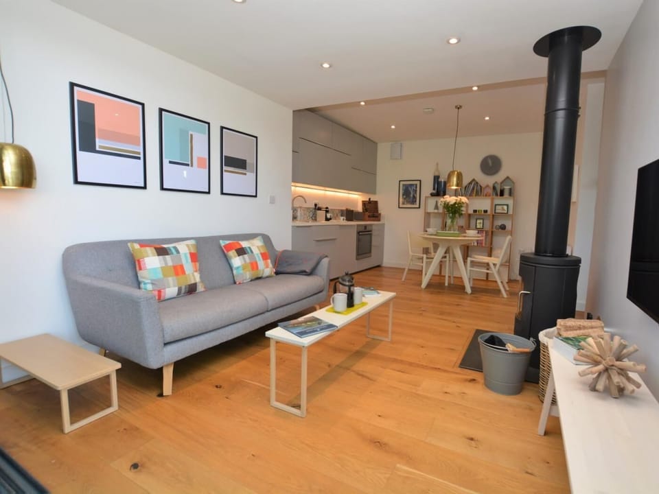 Open-plan living area with cosy wood burner 