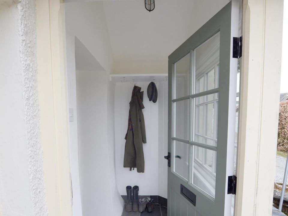 The pretty porch is perfect for coats and muddy boots