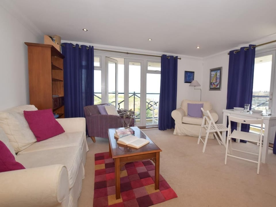 Lounge with two sets of patio doors leading to the wrap-around balcony