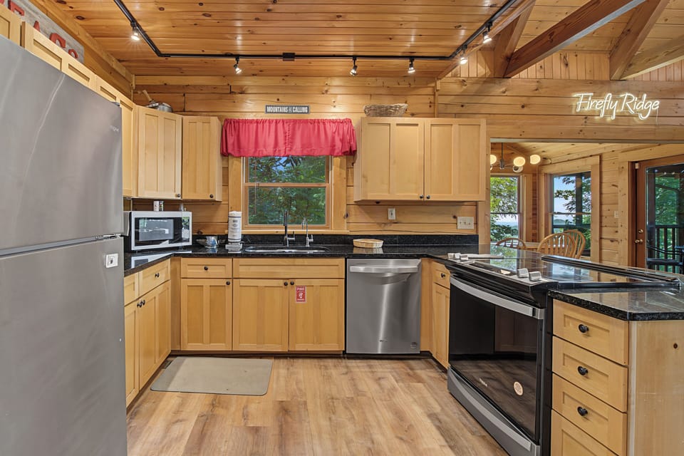 Your fully-equipped mountain kitchen makes meal prep a breeze, with gleaming stainless appliances and warm wood surroundings that blend rustic charm with modern convenience.