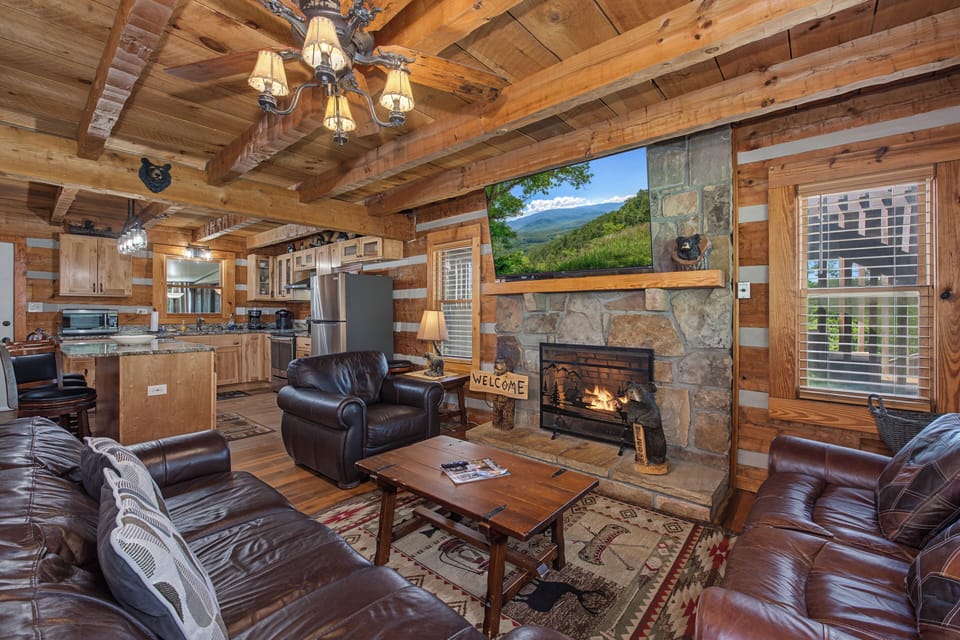 Sink into leather seating, warm up by the stone fireplace, and admire mountain views through the large picture window. The open kitchen invites you to gather and feel right at home in this cozy cabin.