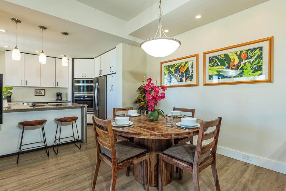 The kitchen flows seamlessly into the dining area—perfect for sharing meals around the beautiful wooden table.