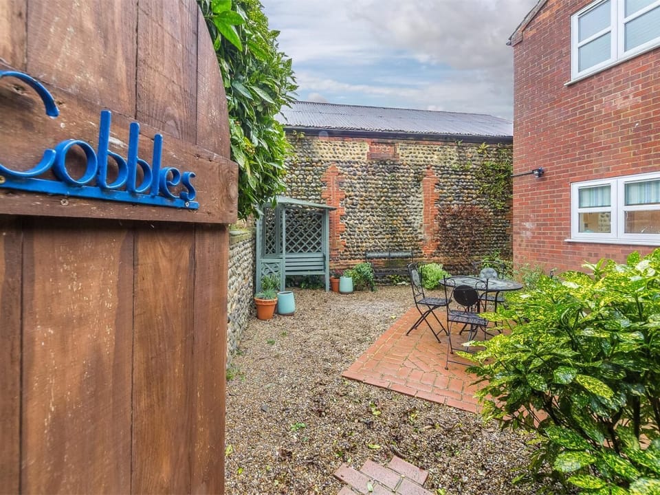 Patio garden is completely enclosed on all sides by stone walls