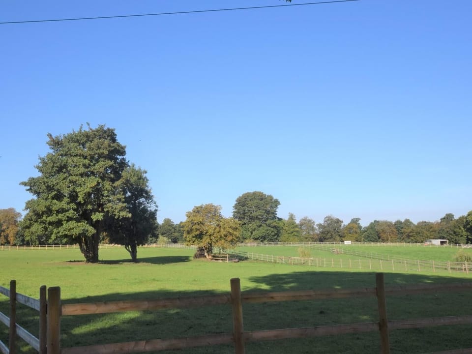 The view to the rear over paddocks and beyond