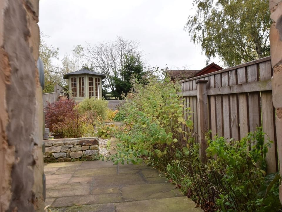 Venture up the stone steps to the garden with seating area and summer house