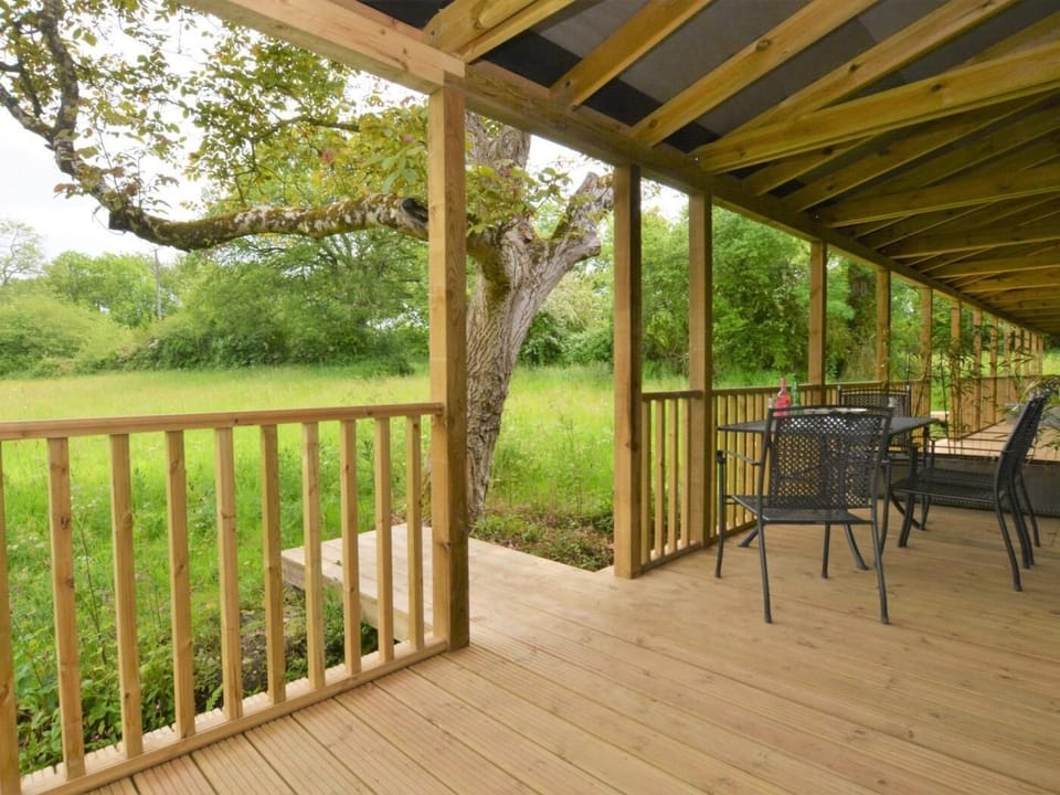 The covered veranda overlooks the paddock and countryside beyond