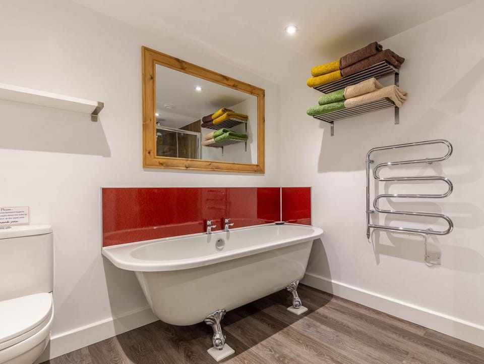 The family bathroom has separate bath and shower