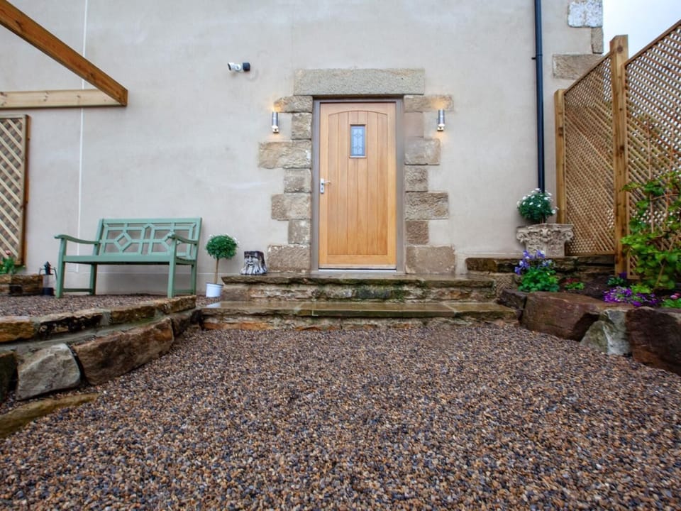 View towards the property with bench to enjoy a morning coffee