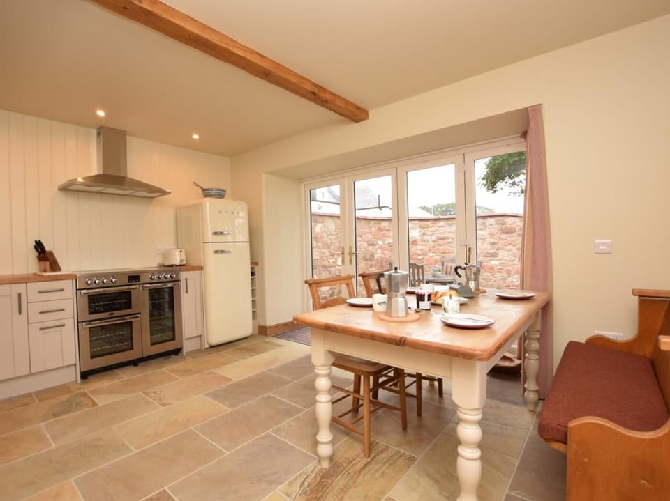The fantastic, bespoke, stylish kitchen/diner with French door leading to the patio