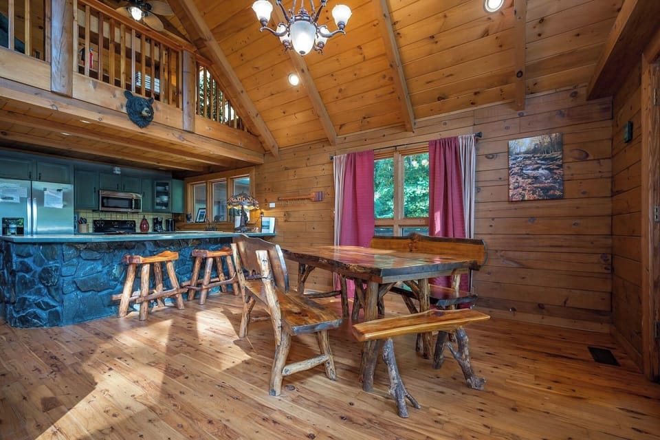 Large hand crafted log dining table , can sit up to 10, with three bar seats at kitchen island. We also have a large picnic table on the covered deck right outside of the dining table.