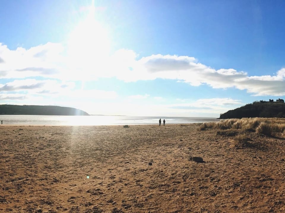 Stroll onto the fabulous beach at Llansteffan with castle overlooking