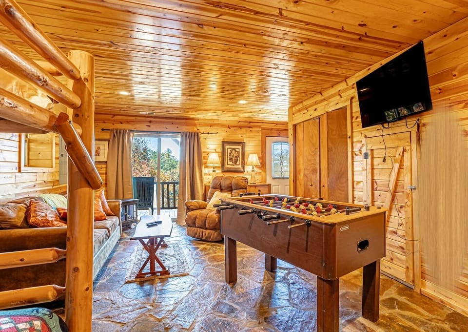 Lower level - 2nd living room with game room- open to large wrap around, fully enclosed lower deck. Lower deck has a gate that can be opened to access back yard.