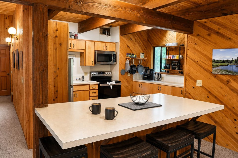 You'll love gathering around this spacious island, fully equipped with modern appliances and rustic wood warmth, perfect for cooking up your favorite meals together.