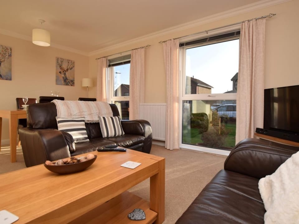 Stylish lounge with front garden views and dining area