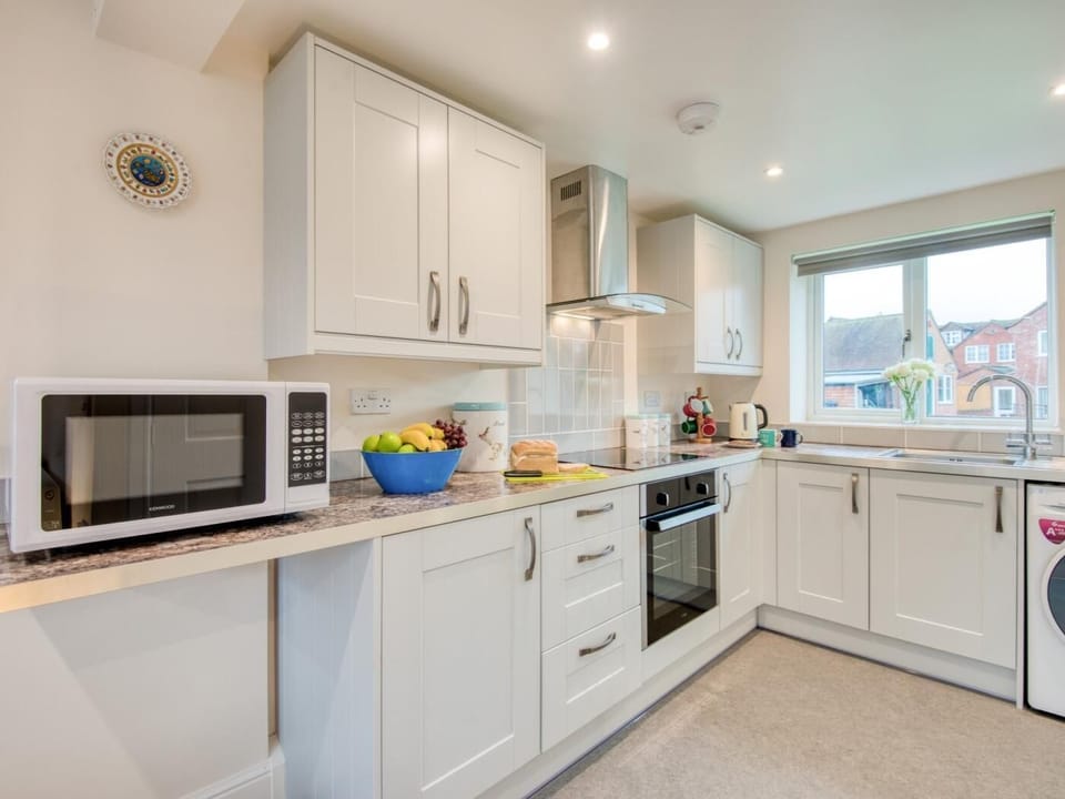 The stylish kitchen area is set into the corner 