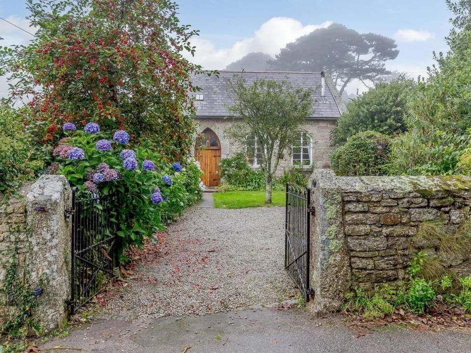 A traditional stone wall frames this lovely country retreat