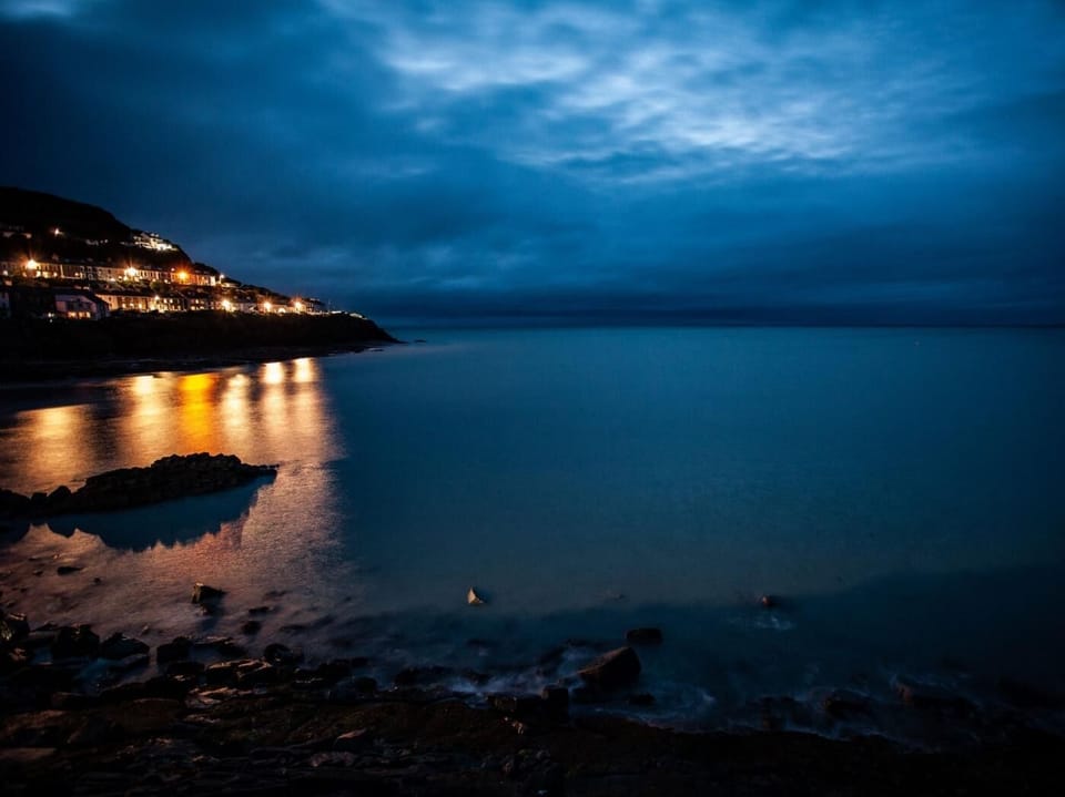 Visit New Quay by night with its lovely beaches and beautiful sunsets