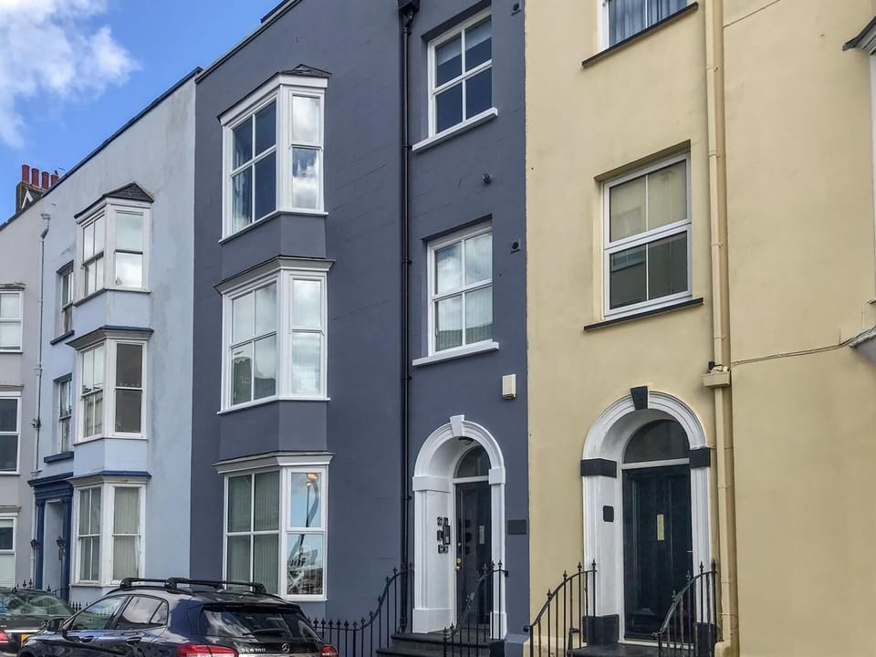 The apartment is located in the dark blue building