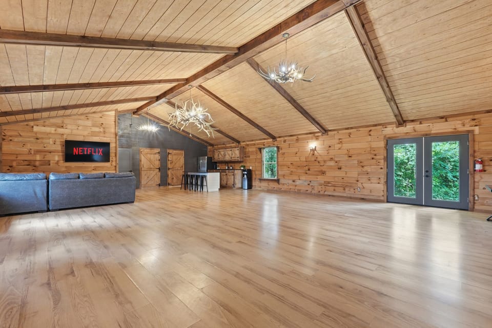 Spacious rustic great room with vaulted ceilings, TV lounge, and bar area