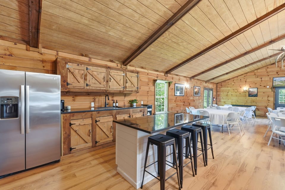 Spacious rustic kitchen with island seating and group dining area