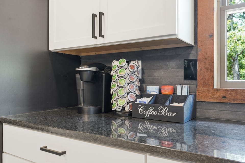 Convenient in-room coffee bar with stocked pods and sleek modern finishes