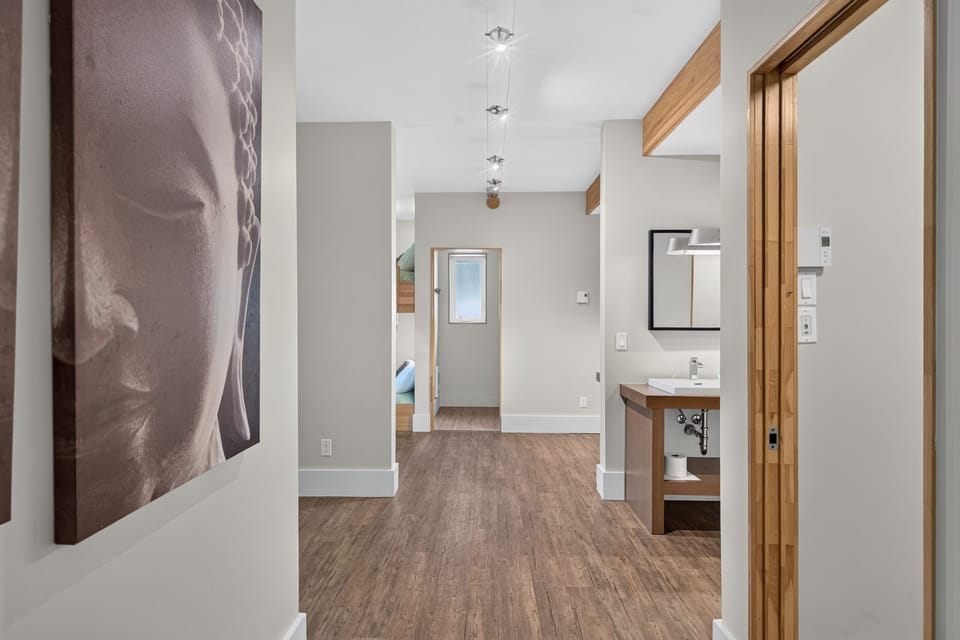 Bright modern hallway with spa-like vanity and warm wood accents