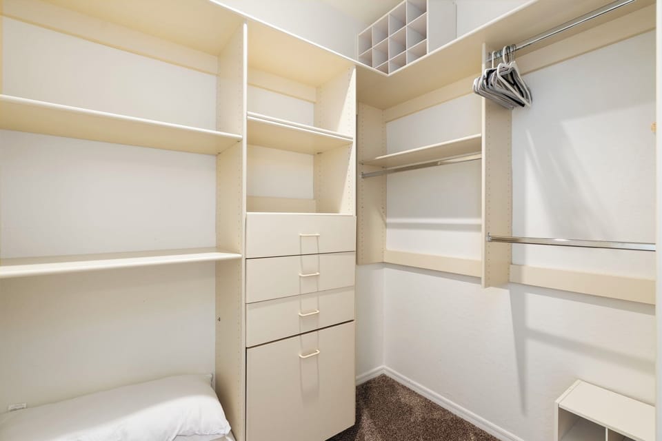 Oversized walk-in closet with built-in shelving.