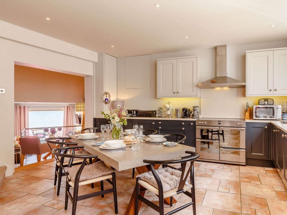 Gather round the ample dining table with the double doors open
