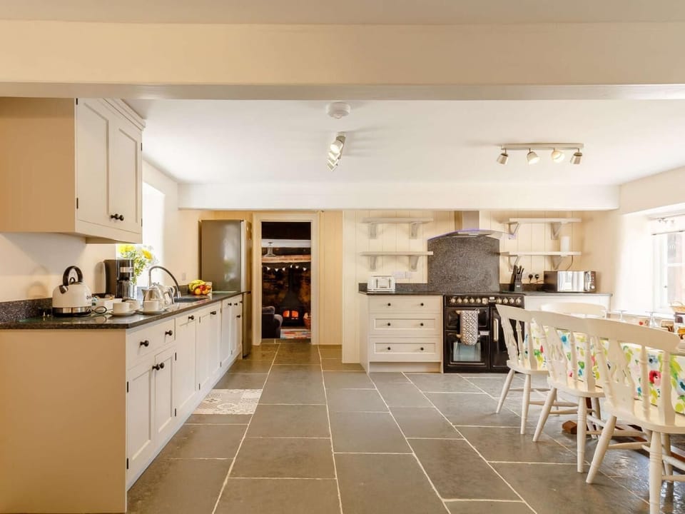 Spacious and sociable kitchen/dining room with a flagstone floor