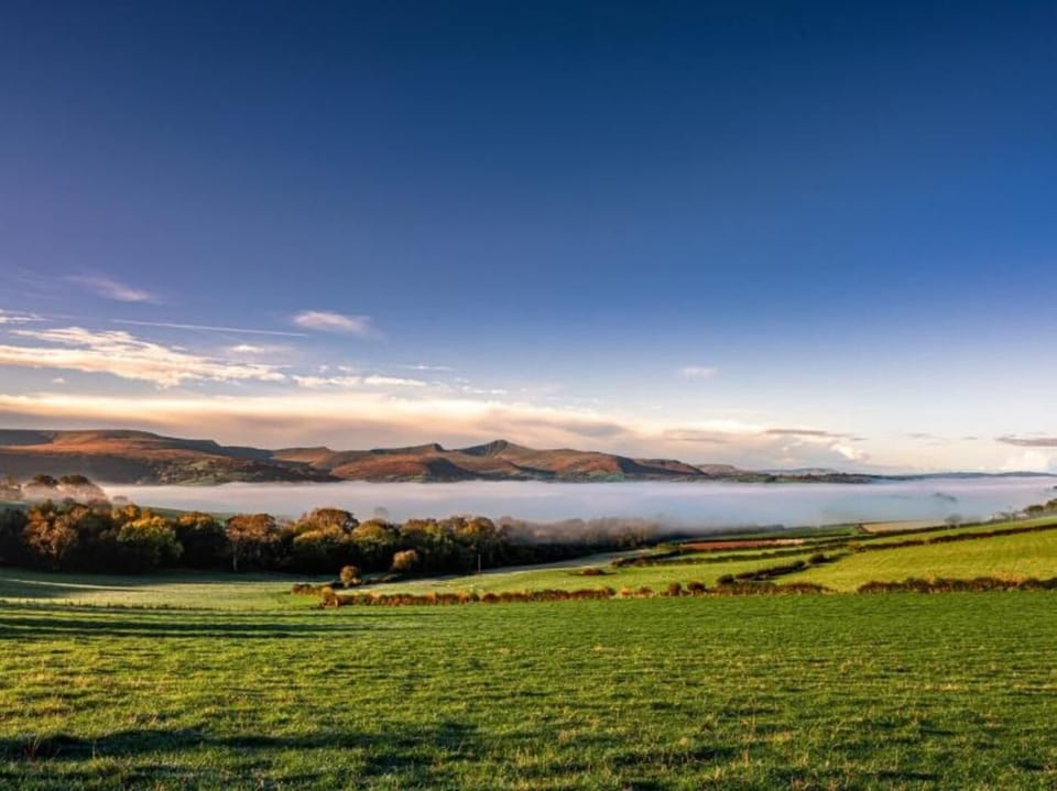 Nearby Llangorse Lake with views over to the Brecon Beacons