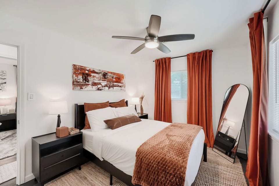 Bedroom 2 with queen bed, nightstands, and calm modern decor