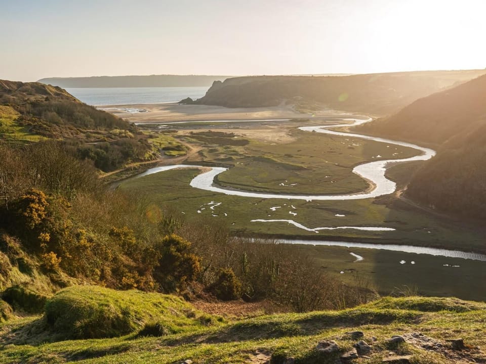 Explore Three Cliffs Bay with its wonderful views and meandering river