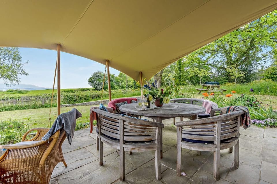 The covered patio is an extension of the kitchen/diner area
