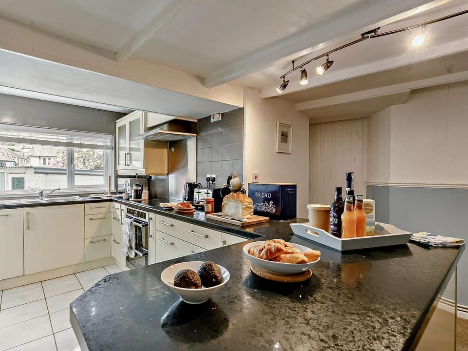 Fully equipped, modern kitchen with convenient door out to garden