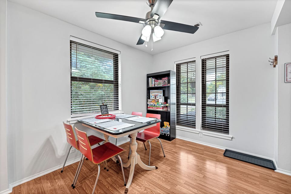 Bright dining area featuring a family board game shelf.
