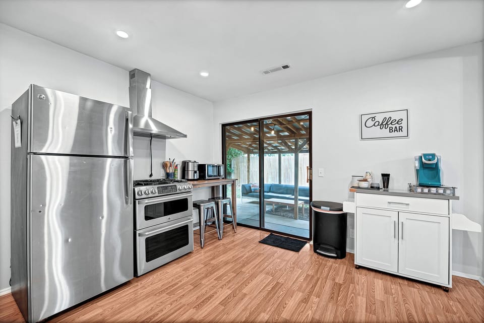 Modern kitchen with a dedicated coffee bar and patio access.