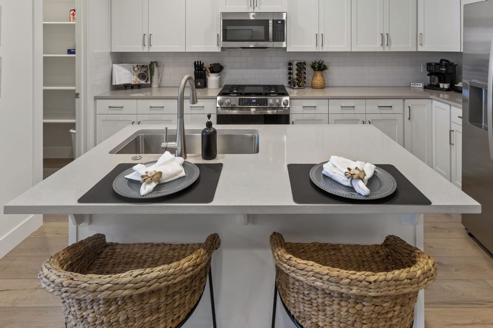 Bright modern kitchen with island seating and sleek stainless appliances