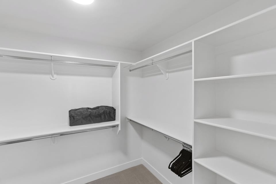 Spacious walk-in closet with shelving and plenty of hanging space