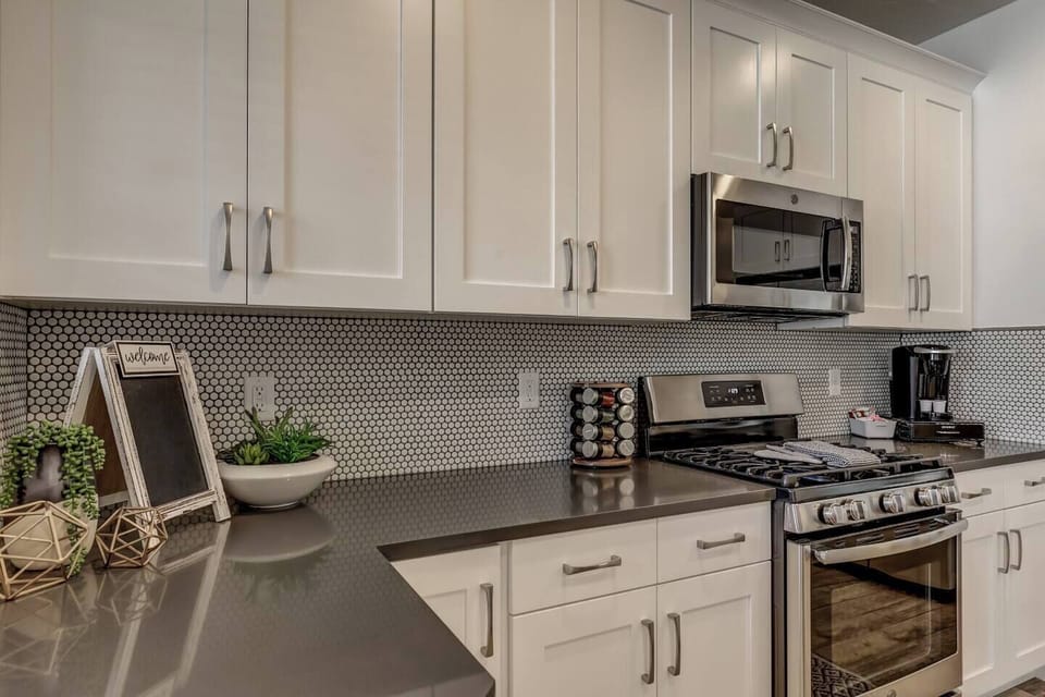 Fully stocked gourmet kitchen featuring stainless steel appliances
