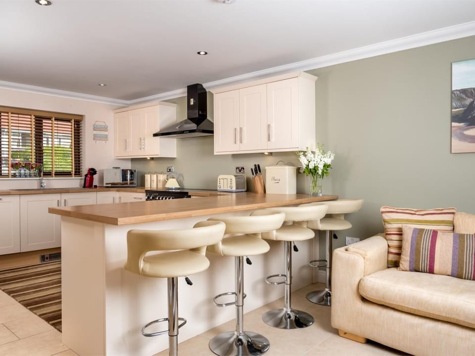 Open plan kitchen and lounge with patio doors onto the outisde terrace 