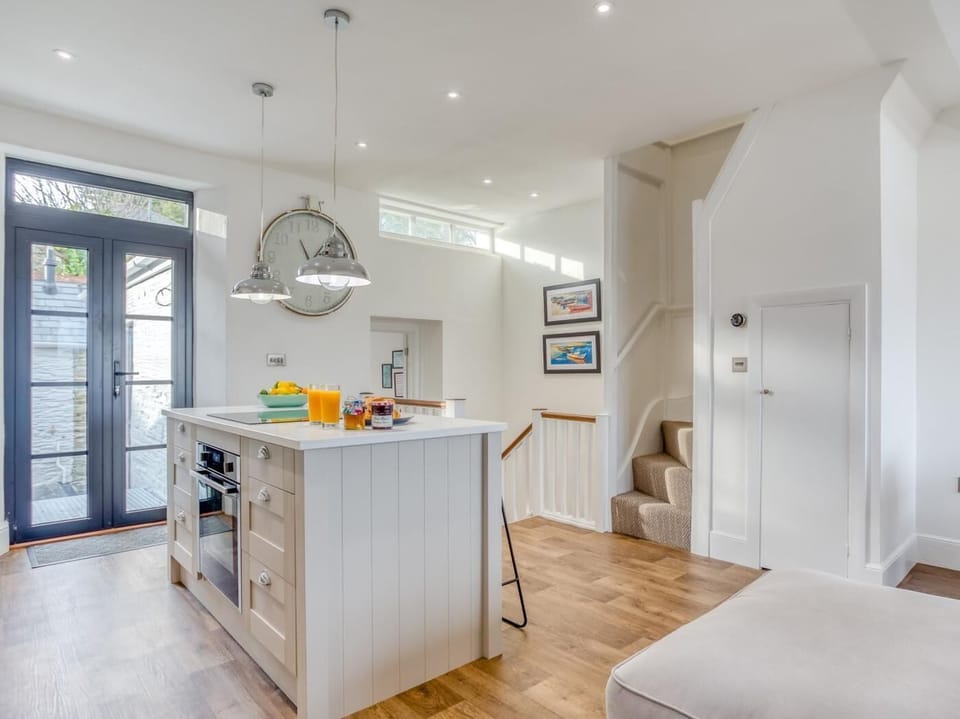 Modern spacious kitchen with doors opening out to the garden